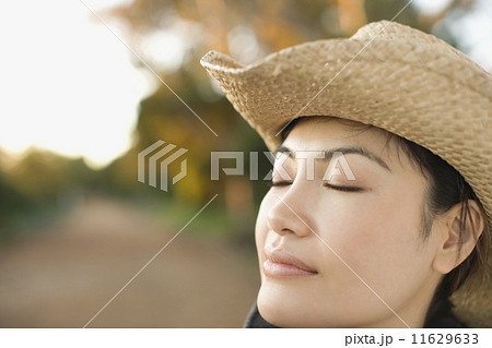 Asian woman wearing cowboy hat 11629633