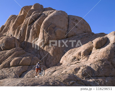 African man with mountain bike on rocks African man with mountain bike on rocks 11629651