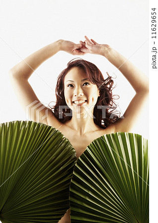 Nude Asian woman covered by large leaves 11629654