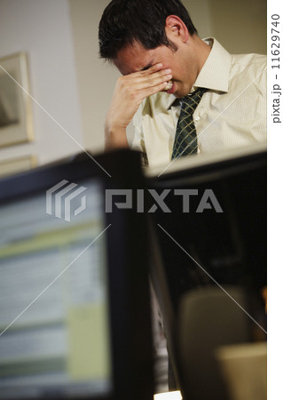 Businessman rubbing his eyes 11629740