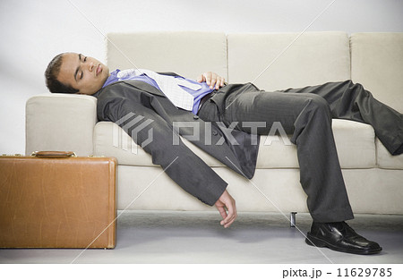 Indian businessman sleeping on sofa Indian businessman sleeping on sofa 11629785