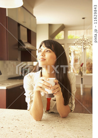 Hispanic woman drinking tea 11629843