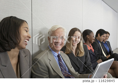 Multi-ethnic businesspeople working on laptops Multi-ethnic businesspeople working on laptops 11629845