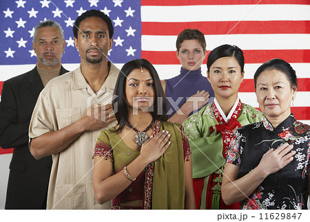 Multi-ethnic people standing in front of American flag 11629847