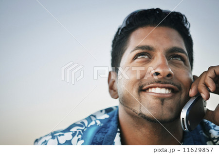 Young man talking on his cell phone Young man talking on his cell phone 11629857