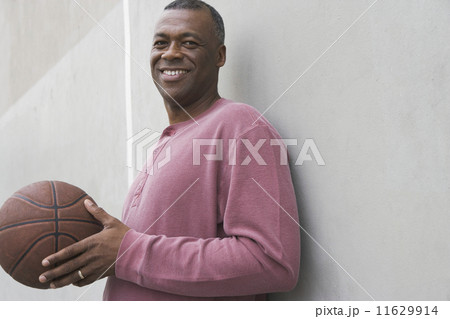 African man smiling with basketball 11629914