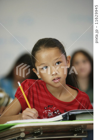 Asian girl at desk in classroom Asian girl at desk in classroom 11629945