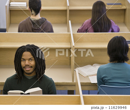 African man reading at library 11629946