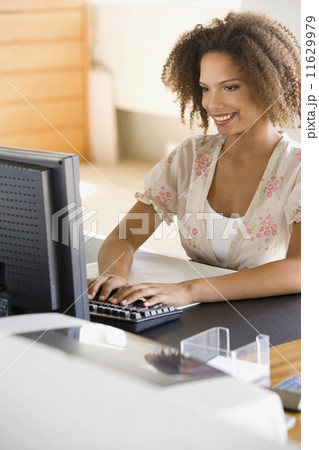 African businesswoman typing on computer 11629979