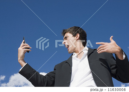 Man yelling at cell phone 11630008