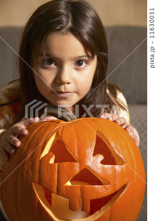 Young Hispanic girl with Jack-o-Lantern Young Hispanic girl with Jack-o-Lantern 11630031