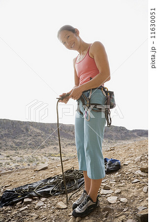 Asian woman in rock climbing gear 11630051