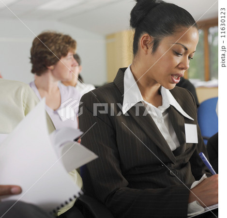 Businesswoman taking notes during conference 11630123
