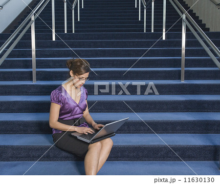 Hispanic businesswoman typing on laptop Hispanic businesswoman typing on laptop 11630130