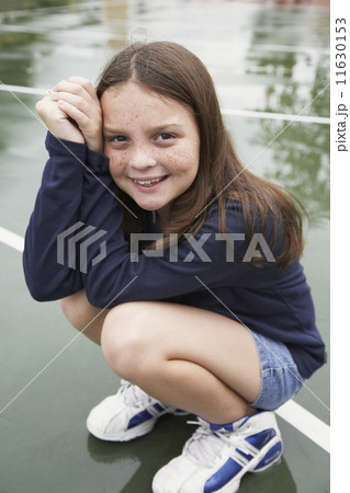 Girl crouching on playground 11630153
