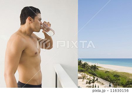Bare-chested Hispanic man drinking water Bare-chested Hispanic man drinking water 11630156