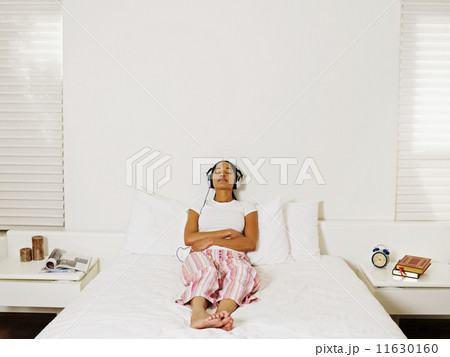 African woman listening to headphones 11630160