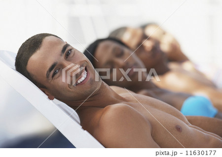 Hispanic man sunbathing 11630177