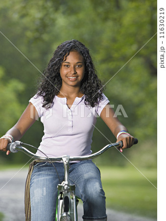 Teenage girl riding a bike 11630219