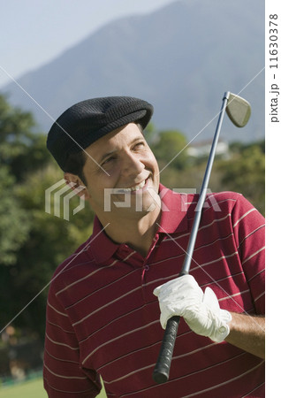 Hispanic man holding golf club over shoulder 11630378