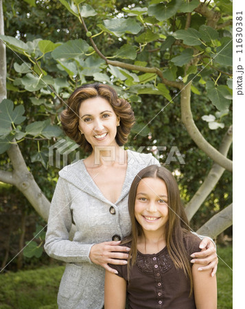 Portrait of Hispanic mother and daughter outdoors 11630381