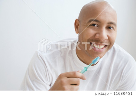 Portrait of Indian man brushing teeth 11630451
