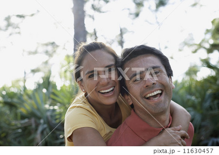 Hispanic man giving girlfriend piggy back ride Hispanic man giving girlfriend piggy back ride 11630457