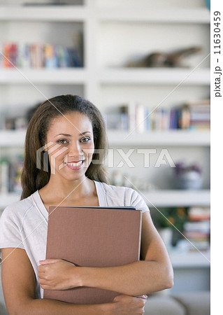 African American woman holding folders African American woman holding folders 11630459