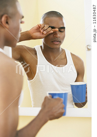 African man rubbing eyes African man rubbing eyes 11630487