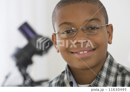 Close up of African boy with microscope in background 11630495