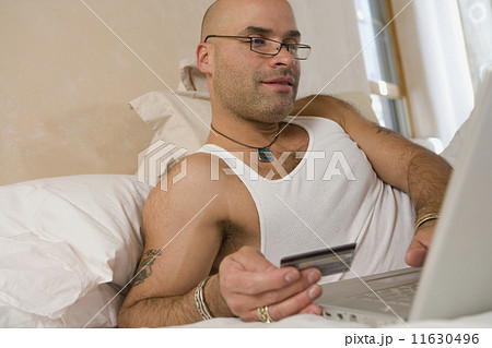 Hispanic man shopping online Hispanic man shopping online 11630496