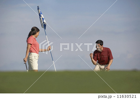 Hispanic couple playing golf 11630521
