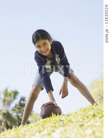 Young Hispanic girl hiking football 11630529