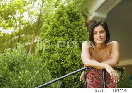 Young woman leaning on railing Young woman leaning on railing 11630544