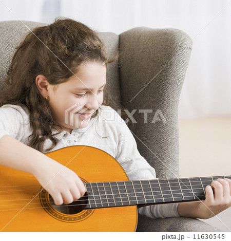 Hispanic girl playing guitar 11630545