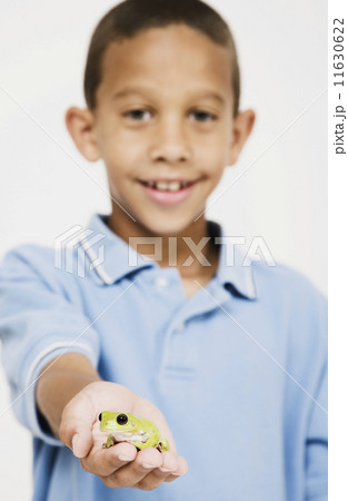 African boy holding frog African boy holding frog 11630622