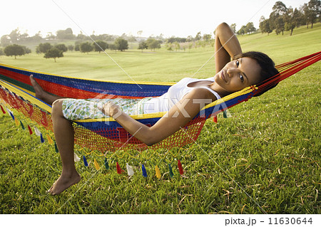 African woman laying in hammock smiling African woman laying in hammock smiling 11630644