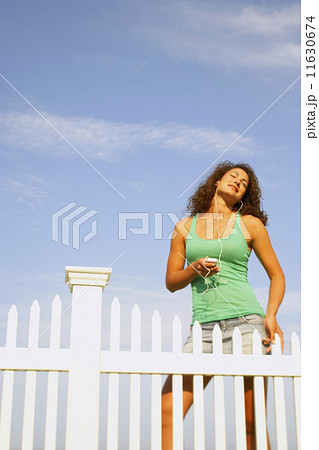 Young woman listening to mp3 player Young woman listening to mp3 player 11630674