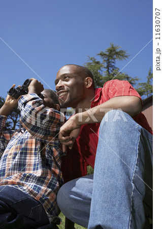 African father and son using binoculars African father and son using binoculars 11630707