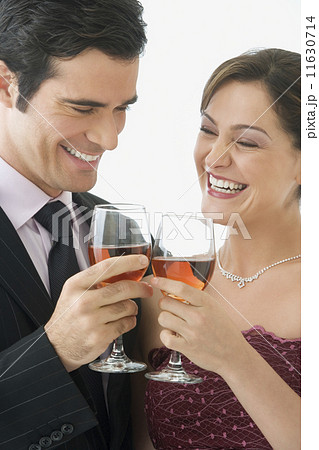 Studio shot of couple toasting with wine glasses Studio shot of couple toasting with wine glasses 11630714