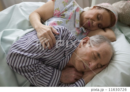 Elderly couple asleep in bed 11630726