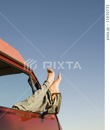 Woman's feet sticking out of car window 11630735