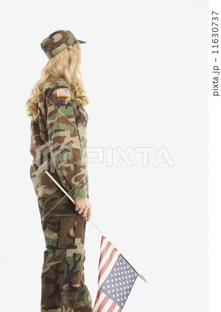 Woman wearing military uniform and holding American flag 11630737