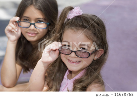Hispanic sisters wearing eyeglasses Hispanic sisters wearing eyeglasses 11630768