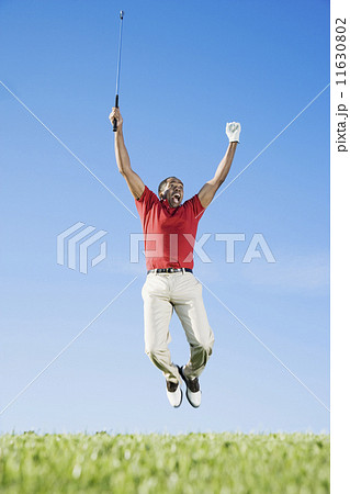 African man cheering on golf course African man cheering on golf course 11630802