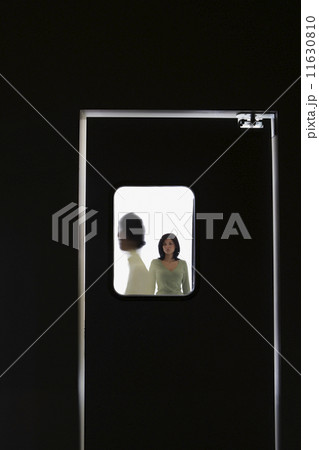 People standing behind door window People standing behind door window 11630810