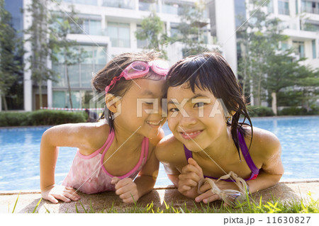 Asian sisters getting out of swimming pool Asian sisters getting out of swimming pool 11630827