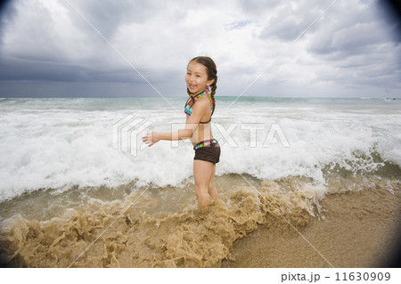 Asian girl playing in surf 11630909