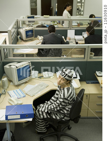 Hispanic businesswoman wearing convict's clothing 11630910