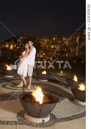 Couple hugging at resort hotel at night Couple hugging at resort hotel at night 11630916